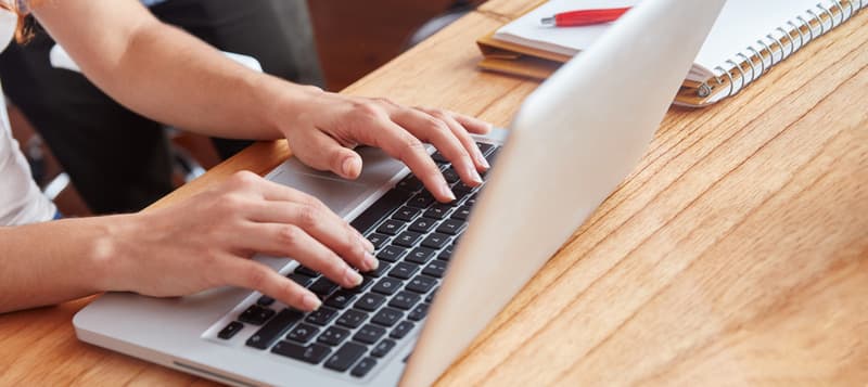 woman hands typing on laptop 