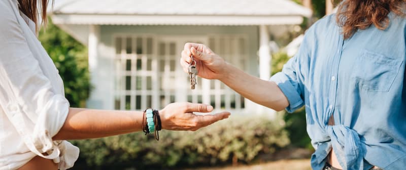 Couple handshaking realtor after signing contract